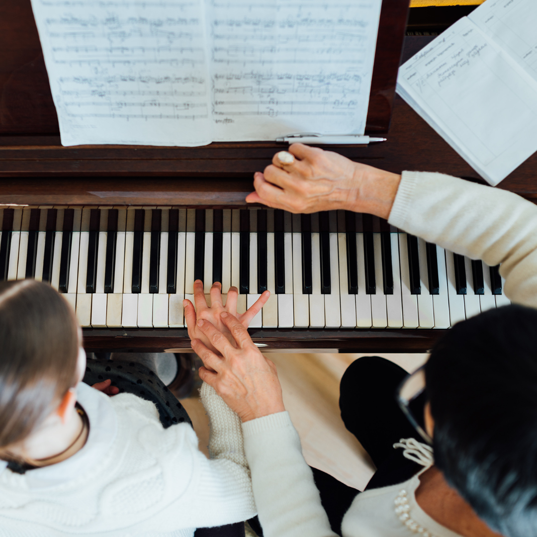 Student playing piano during an in-home piano lesson